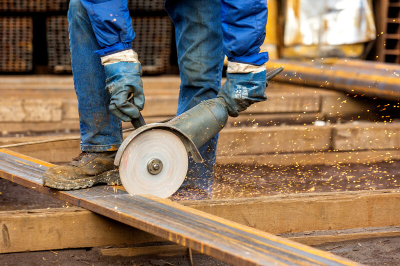 A person chops steel plate